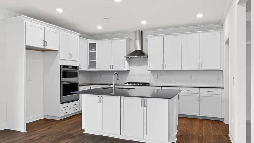 kitchen with white cabinets spacious island and quartz countertops