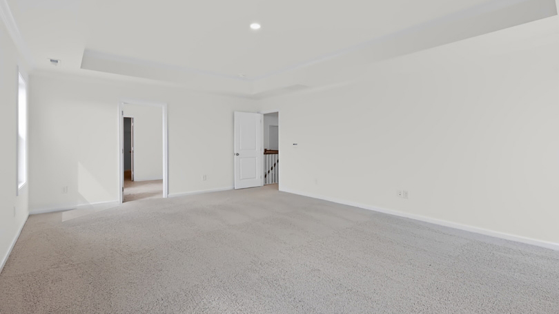 primary bedroom with carpet flooring