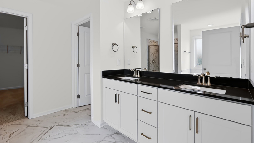 primary bathroom with dual vanity and quartz countertops