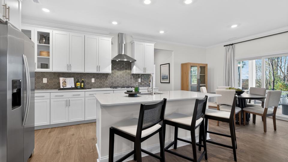 kitchen with quartz counters, kitchen island, pantry, stainless steel appliances