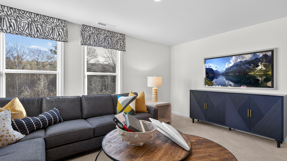 upstairs loft area with large windows and carpeting