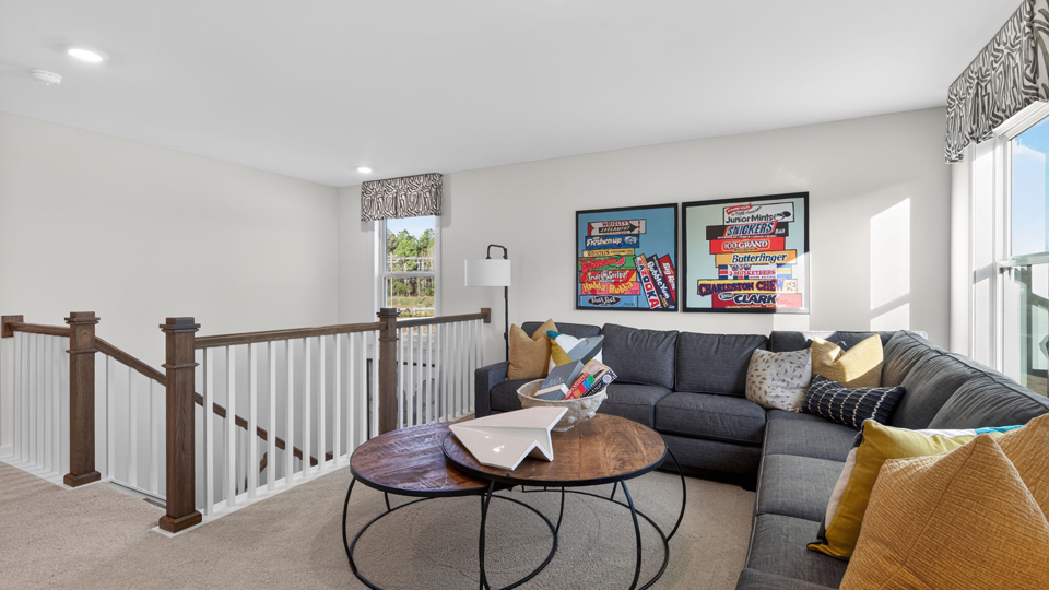 upstairs loft area with large windows and carpeting
