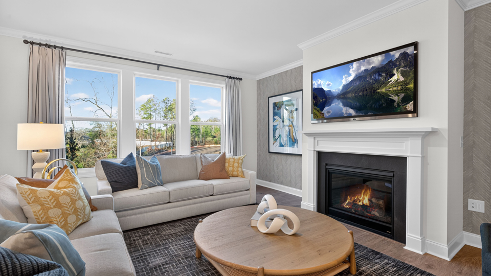 open concept living space with large windows, fireplace