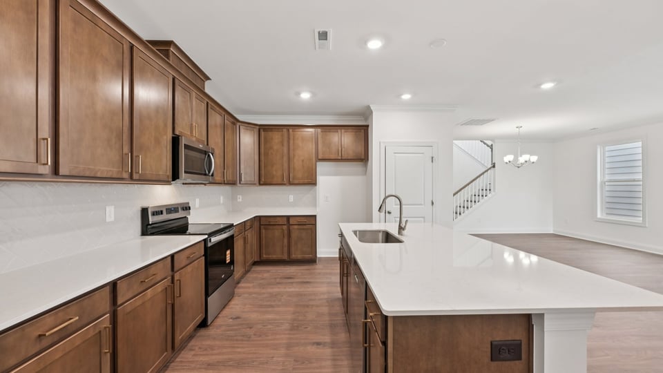 kitchen with brown cabinets quartz countertops and kitchen island
