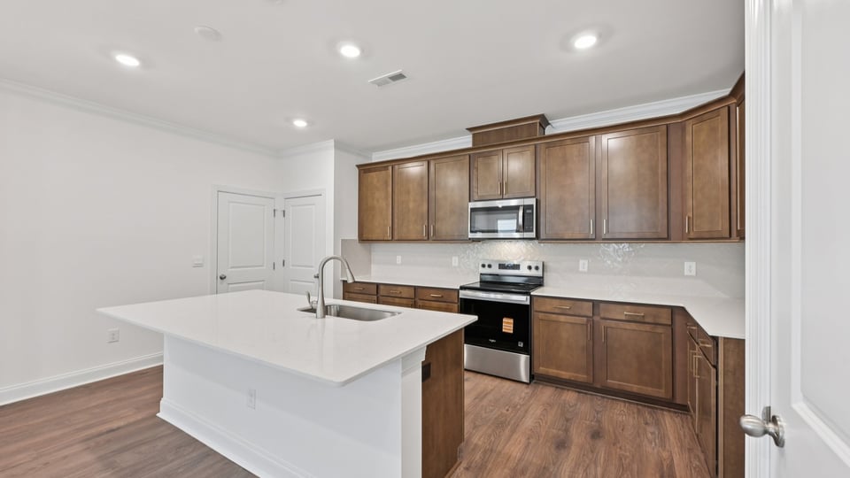 kitchen with brown cabinets quartz countertops and kitchen island