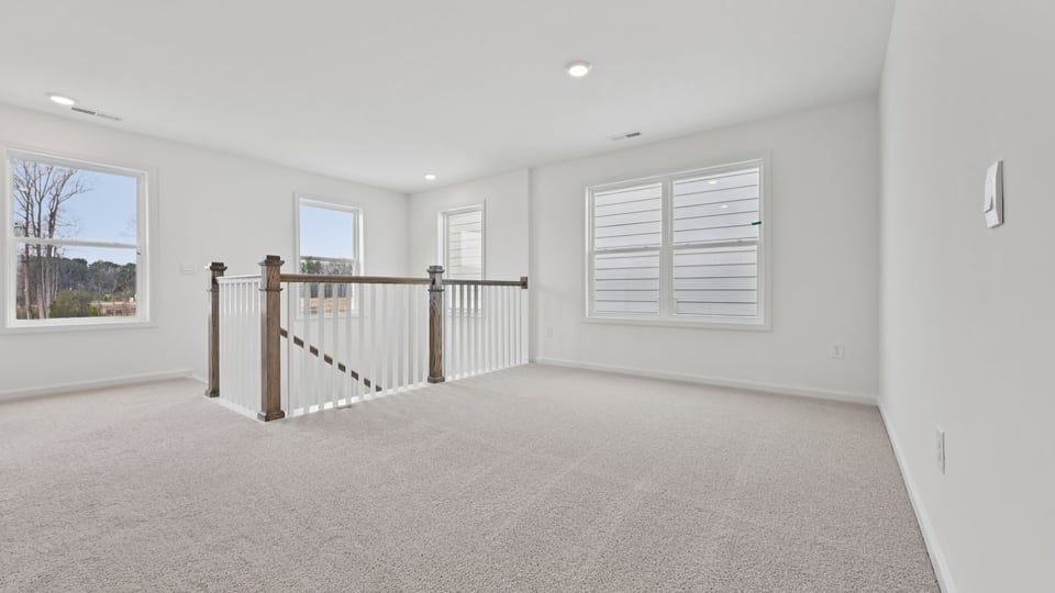 loft area with carpet flooring