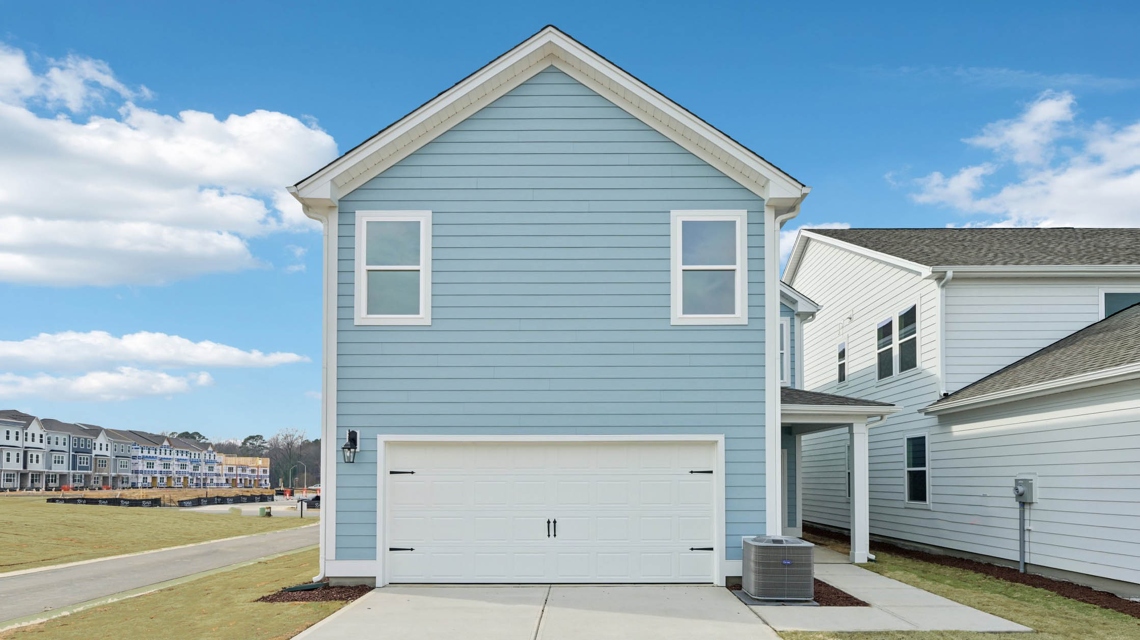 back of home with two car garage on corner lot