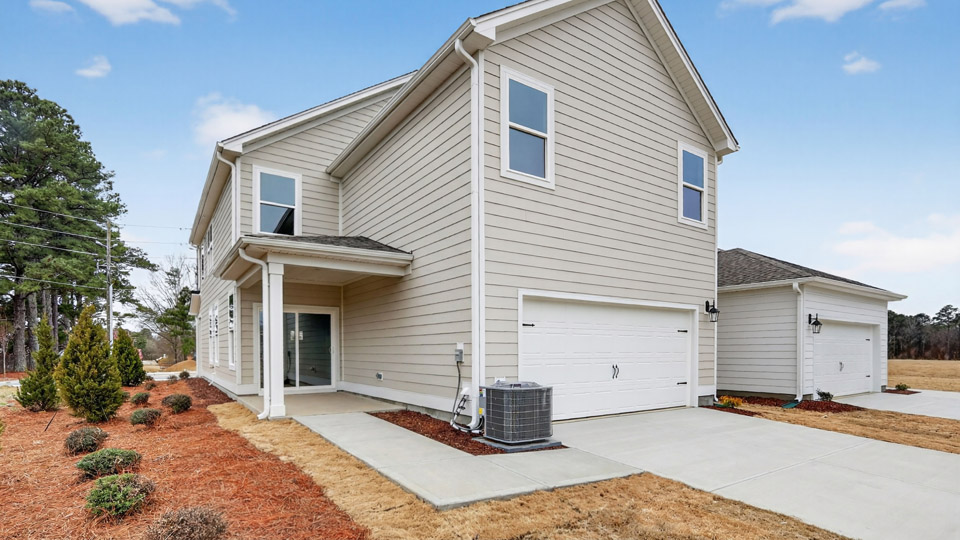 Covered back patio leading to 2 car garage