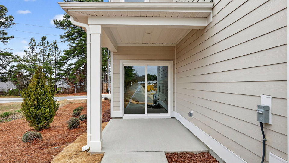 Covered back patio leading to garage