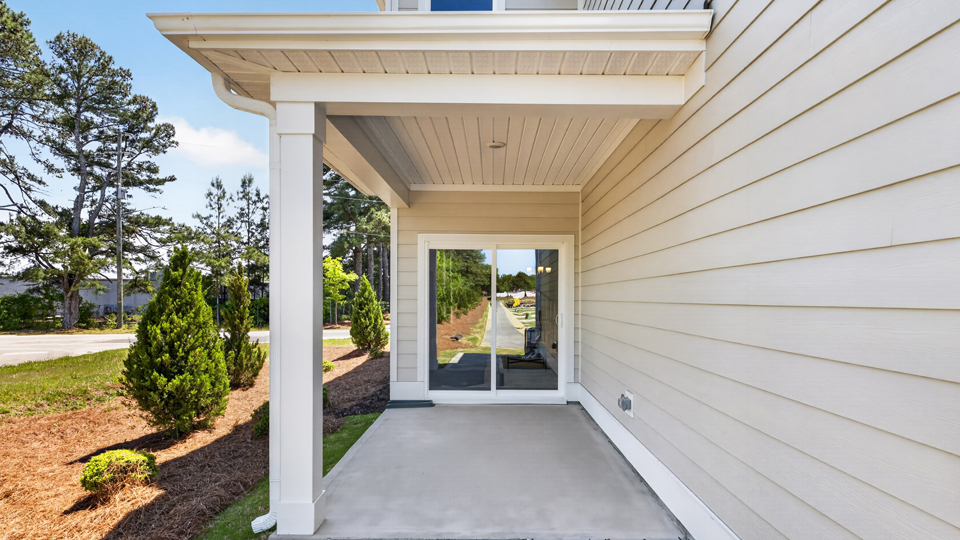 Covered back patio leading to garage