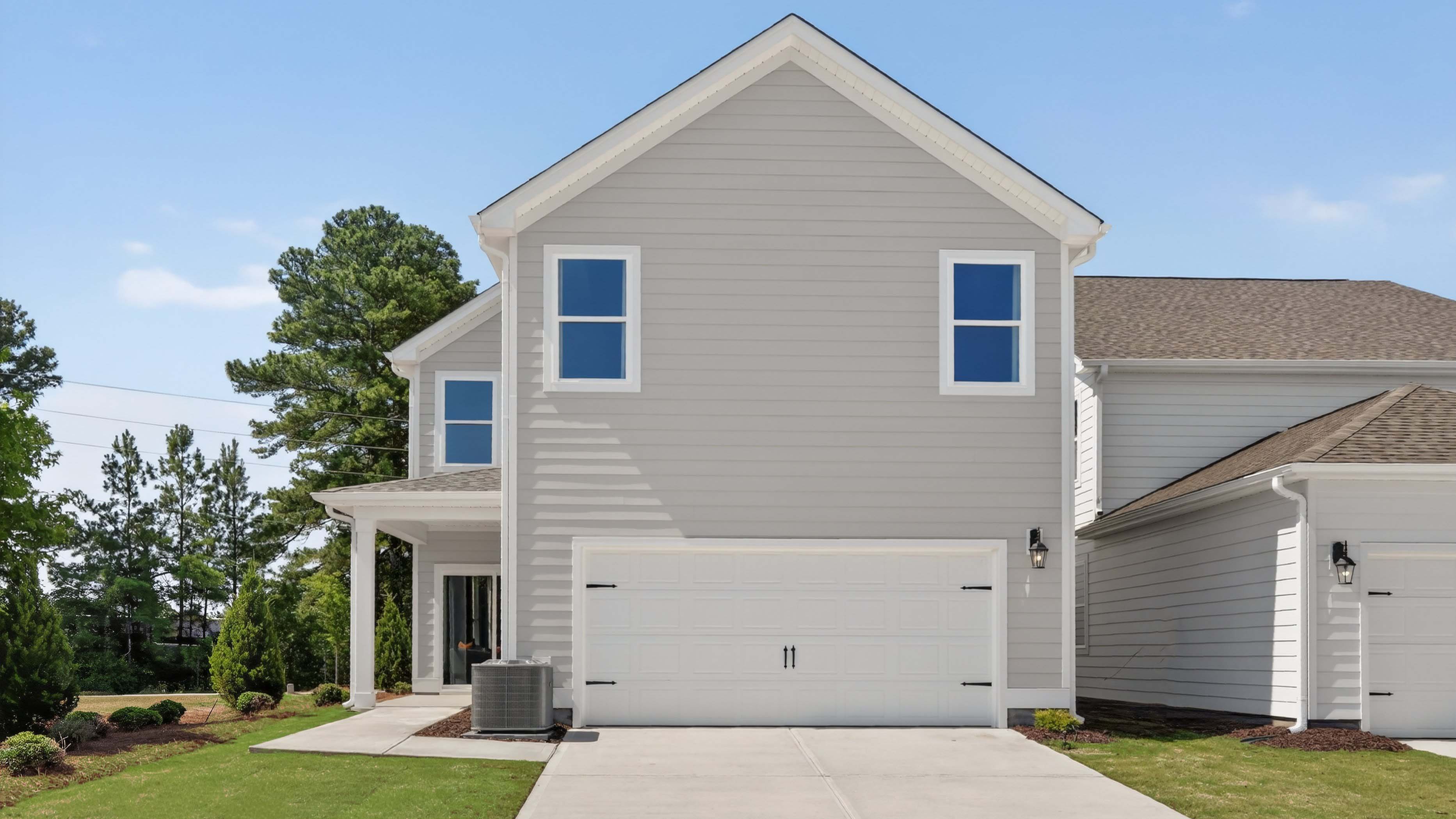 back of alec with two car garage and covered patio
