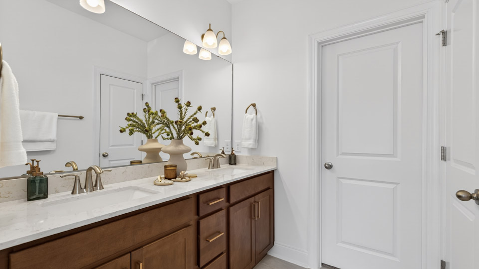 secondary bathroom with walk in shower and single vanity sink