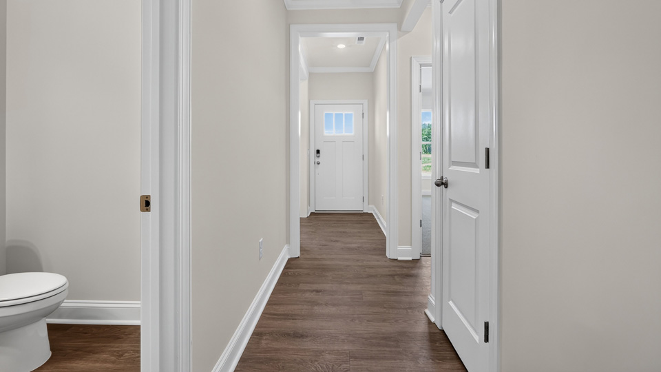 foyer entryway with powder room on left