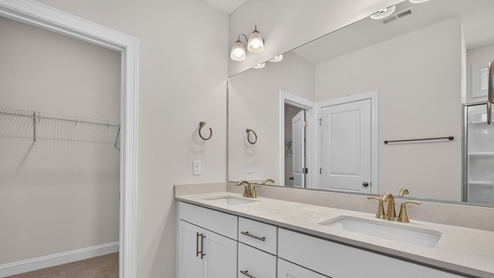 bathroom with white cabinets quartz countertops and dual vanity