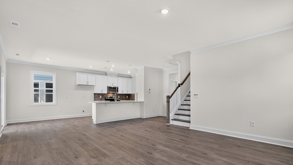 open concept living room overlooked by kitchen