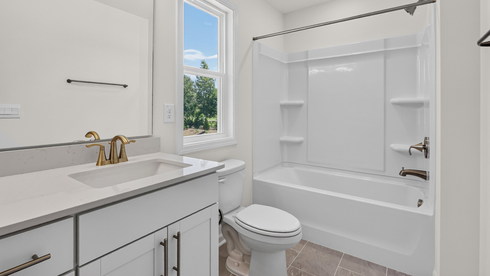 bathroom with tub shower combo and quartz countertops