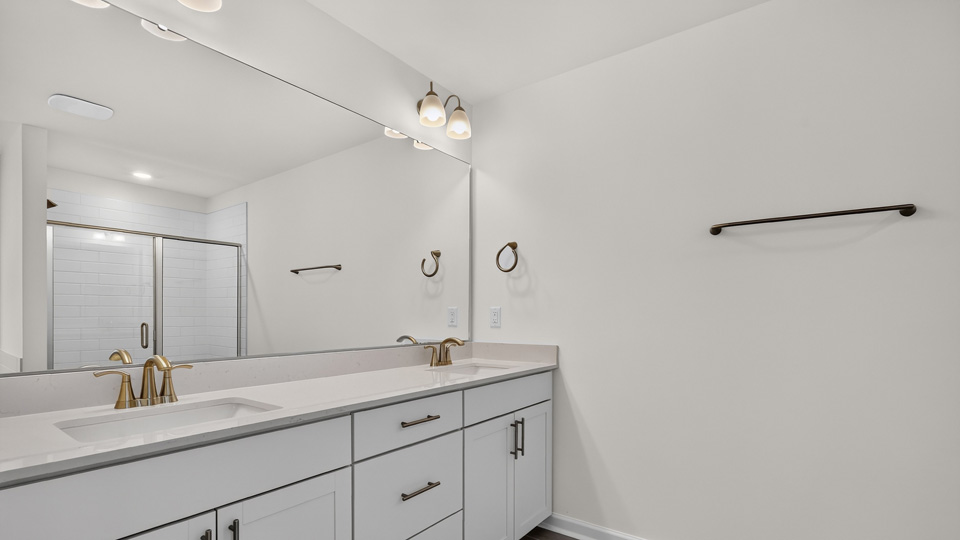 bathroom with quartz countertops and white cabinets