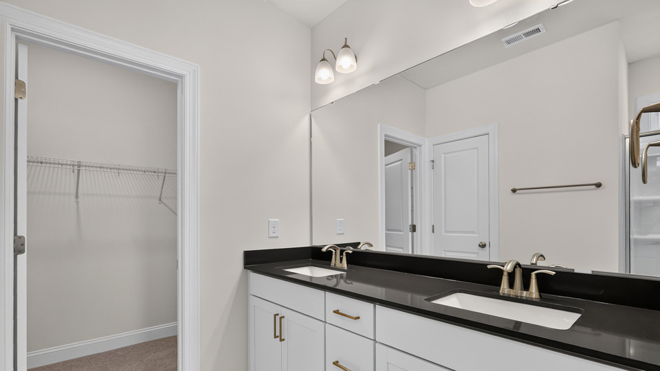 bathroom with quartz countertops white cabinets and dual vanity