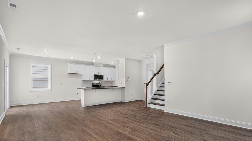 open concept living area overlooked by kitchen