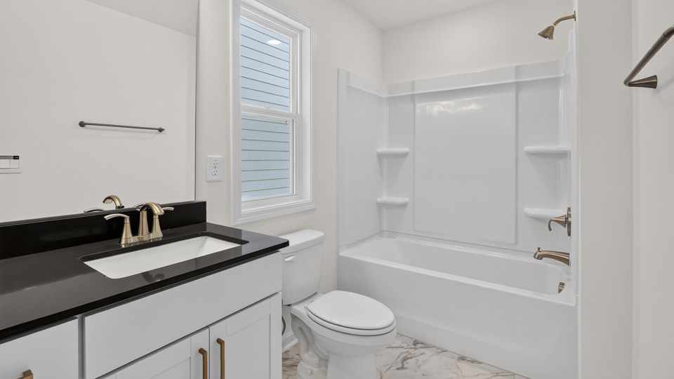 bathroom with tub shower combo and quartz countertops