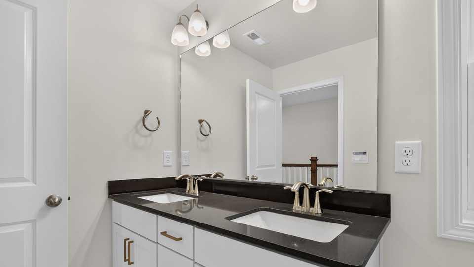 bathroom with dual vanity quartz countertops