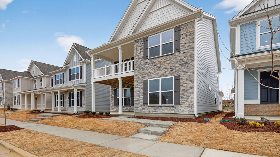 Two story home with white colored siding with a two car garage