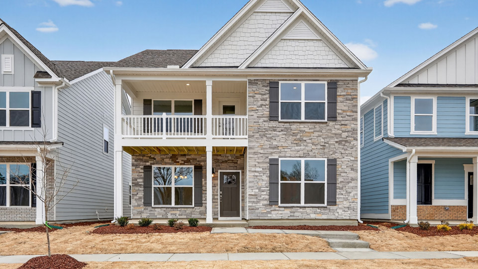 Two story home with white colored siding with a two car garage