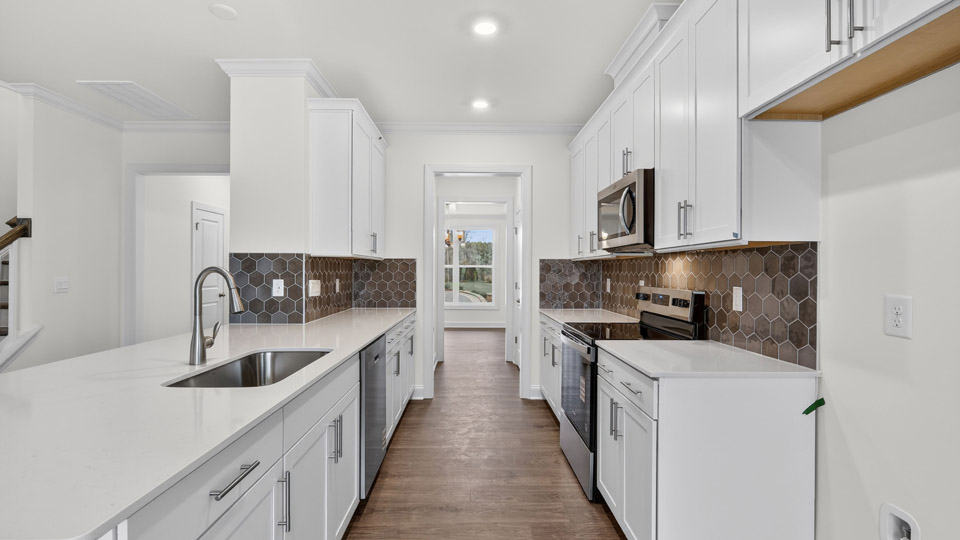 Kitchen with white cabinets and stainless steel appliances.