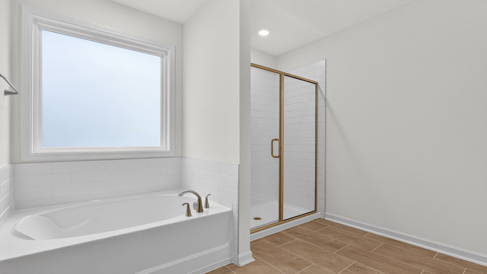 Primary bathroom with double sink with a walk-in shower and tub