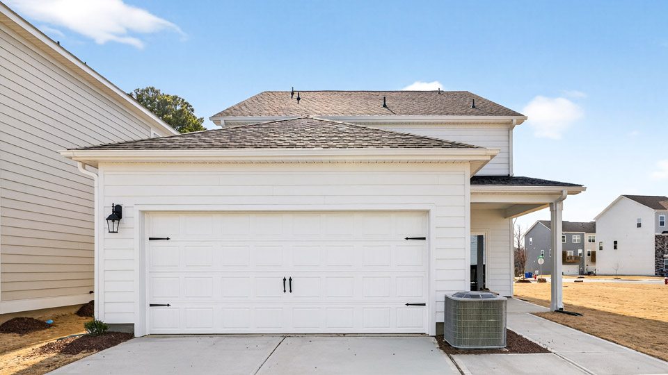 back of home with two car garage
