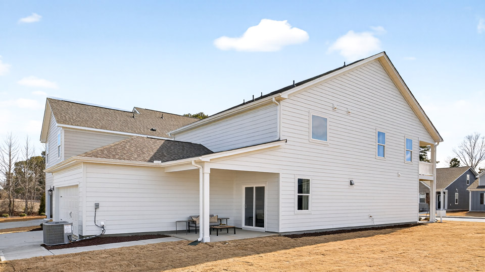 back of home with covered concrete patio