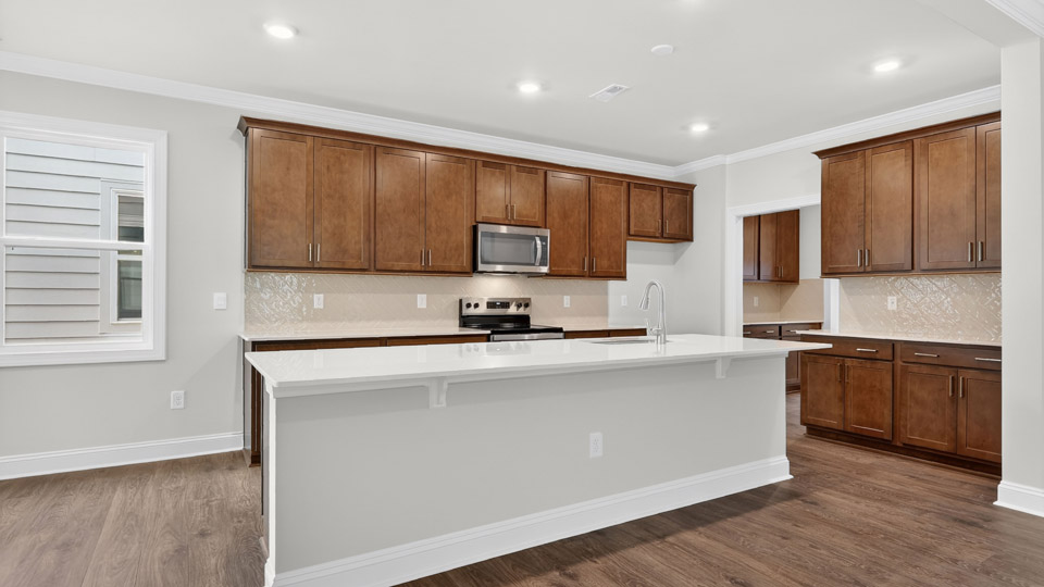 Kitchen with brown cabinets and stainless steel appliances.