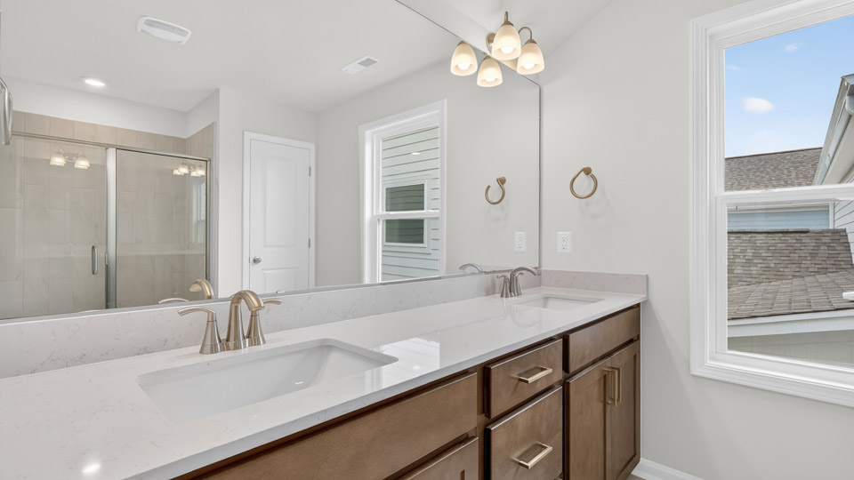 Primary bathroom with double sink and walk-in shower