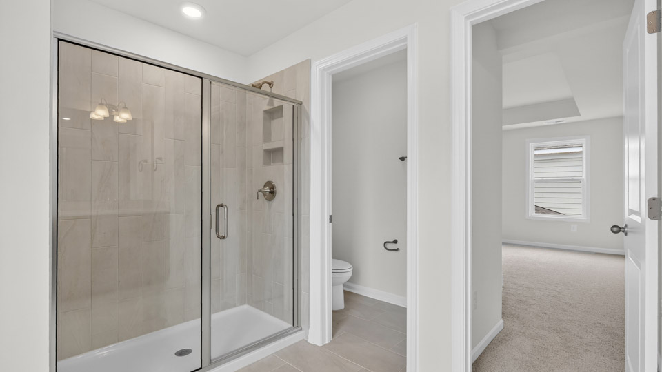 Primary bathroom with double sink and walk-in shower