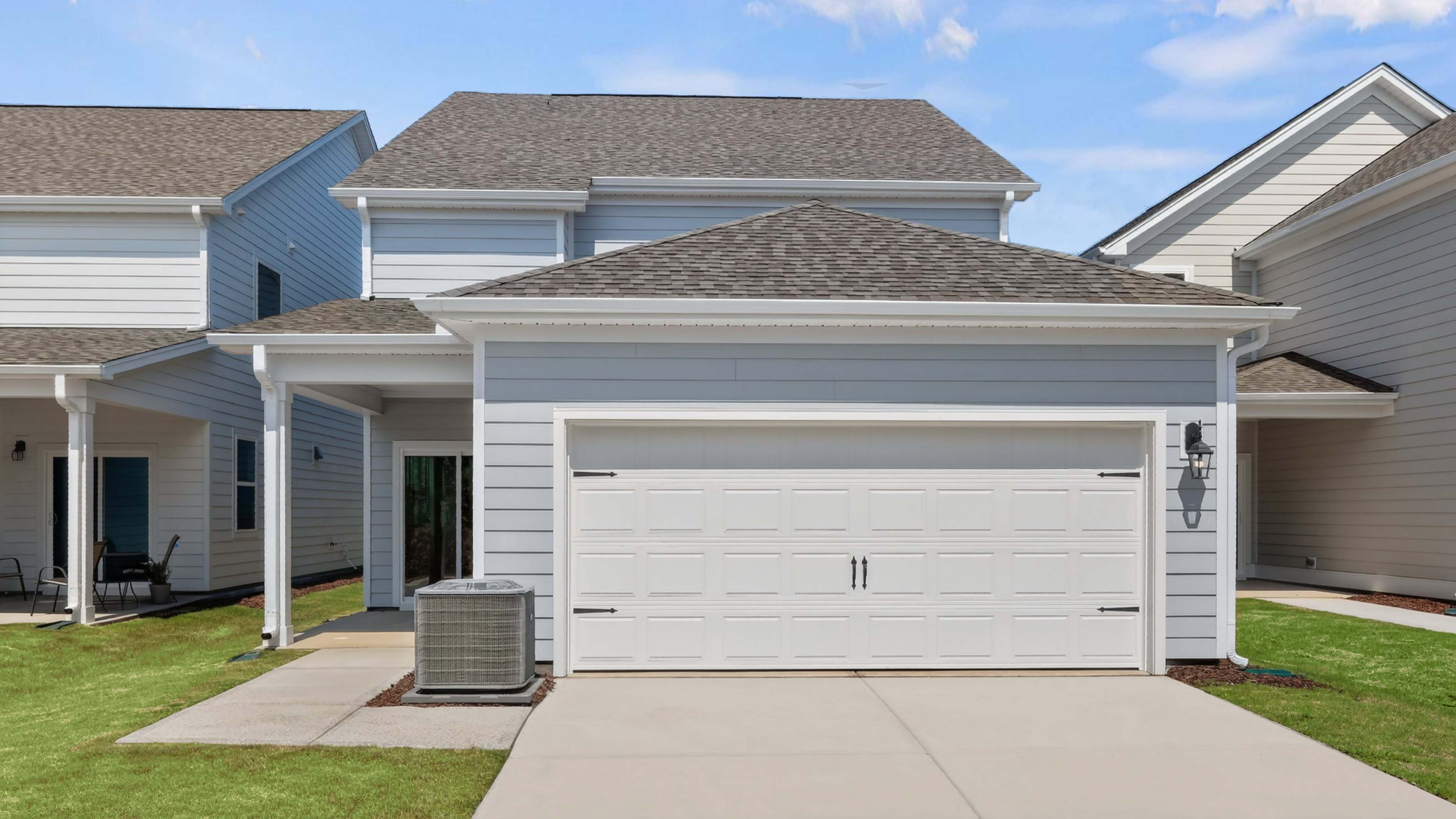 back of jackson with two car garage and covered patio