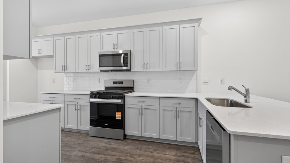 Kitchen with white cabinets and stainless steel appliances.
