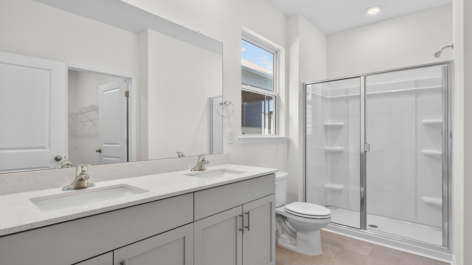 Primary bathroom with double sink and walk-in shower