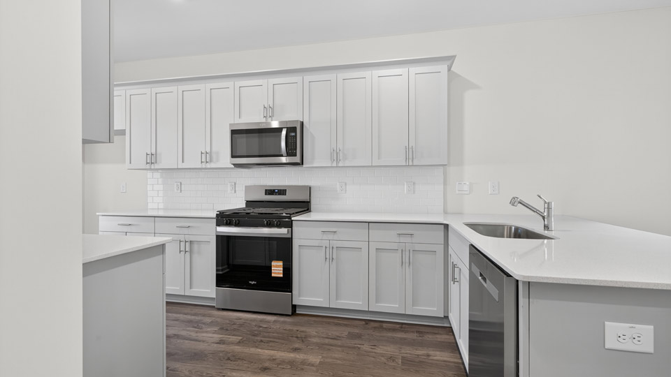 Kitchen with white cabinets and stainless steel appliances.