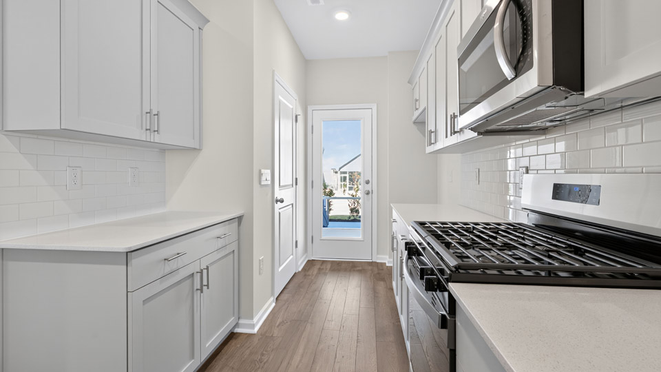 Kitchen with white cabinets and stainless steel appliances.