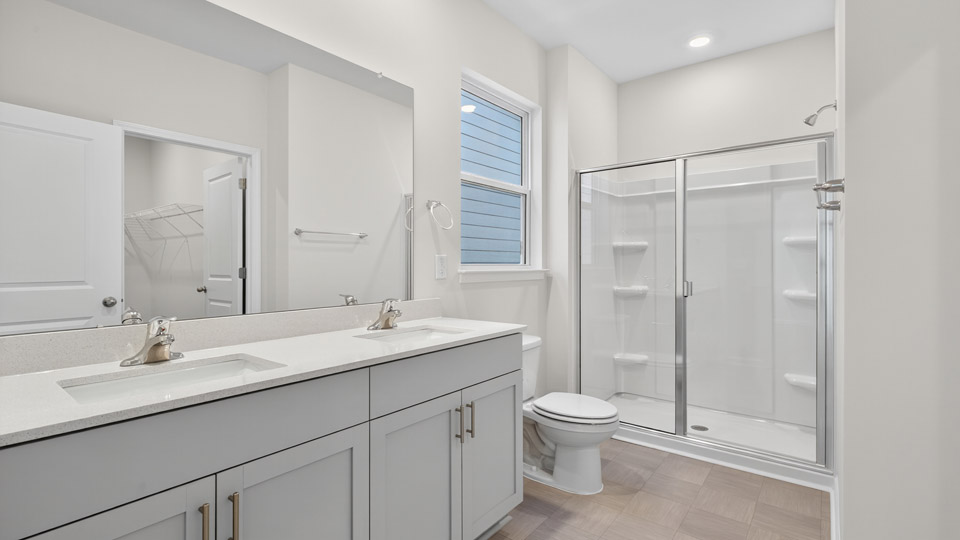 Primary bathroom with double sink and walk-in shower