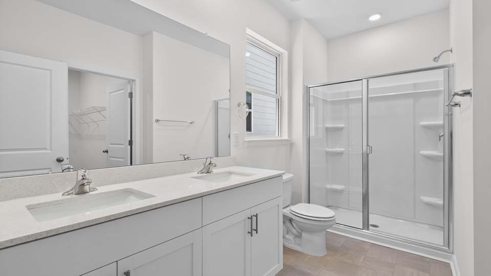 Primary bathroom with double sink and walk-in shower