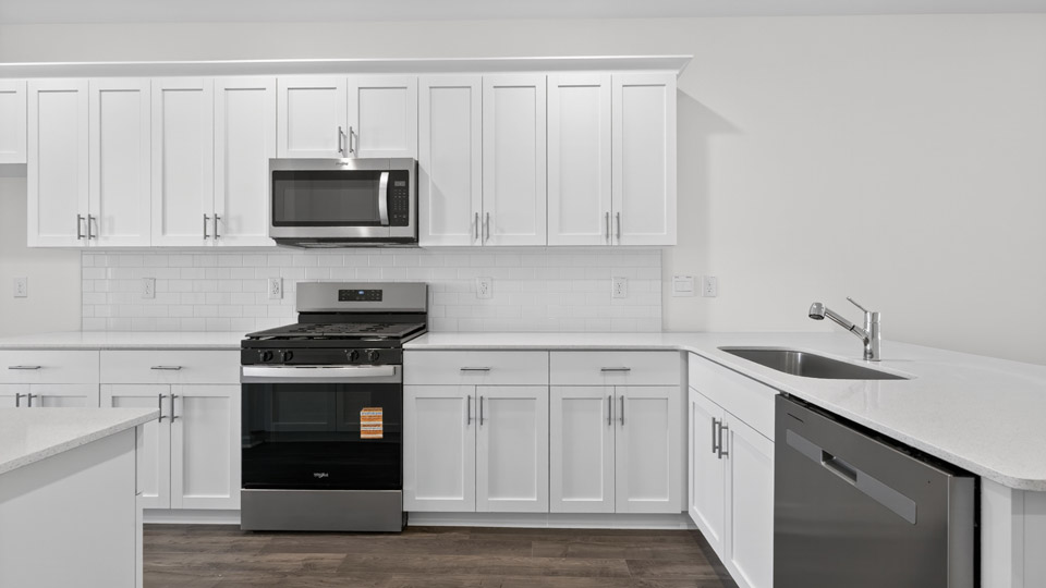 Kitchen with white cabinets and stainless steel appliances.
