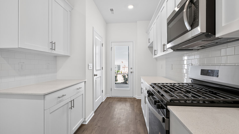 Kitchen with white cabinets and stainless steel appliances.