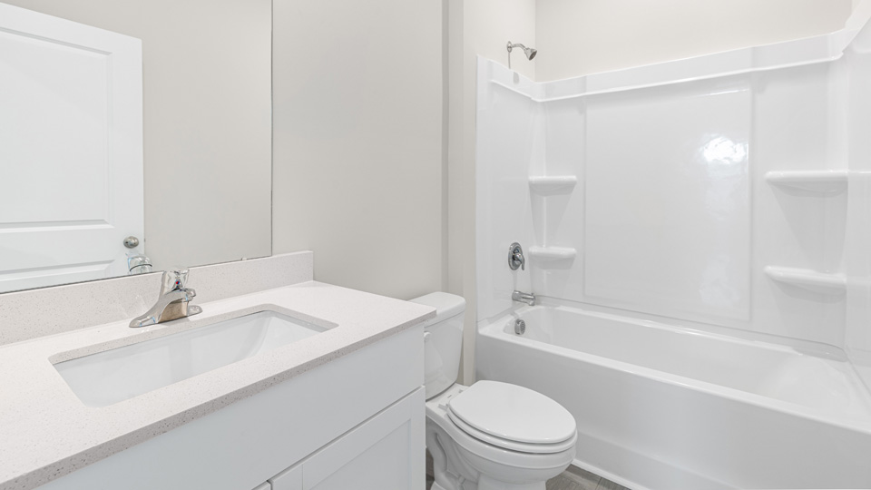 secondary bathroom with shower tub combo and single vanity sink