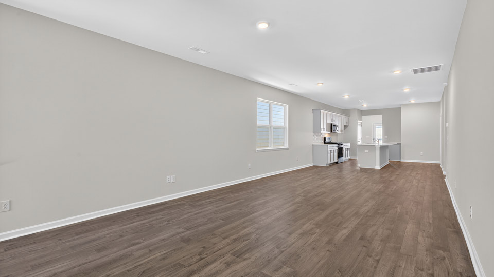 Open-concept living room leading to kitchen