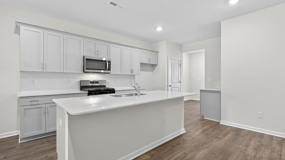 Kitchen with white cabinets and stainless steel appliances.