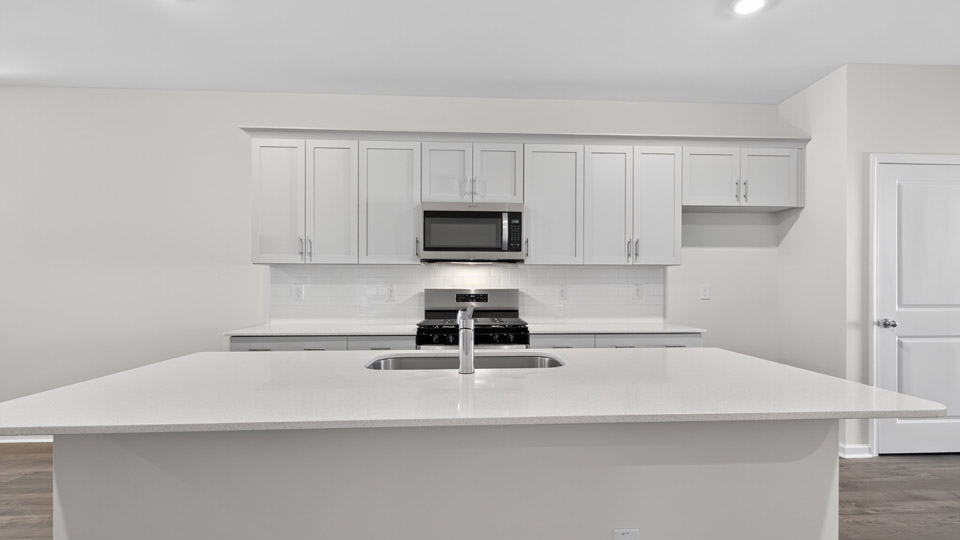 Kitchen with white cabinets and stainless steel appliances.