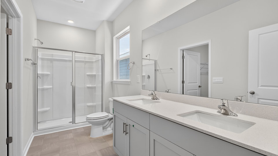 Primary bathroom with double sink and walk-in shower
