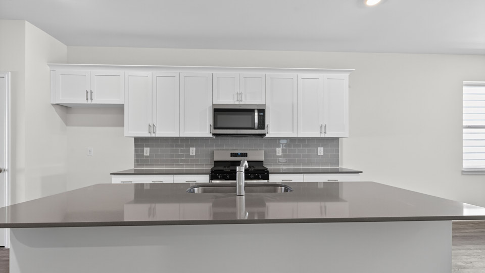 Kitchen with white cabinets and stainless steel appliances.