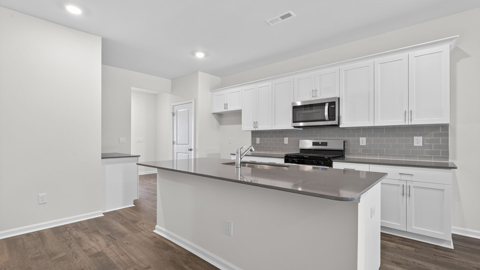 Kitchen with white cabinets and stainless steel appliances.